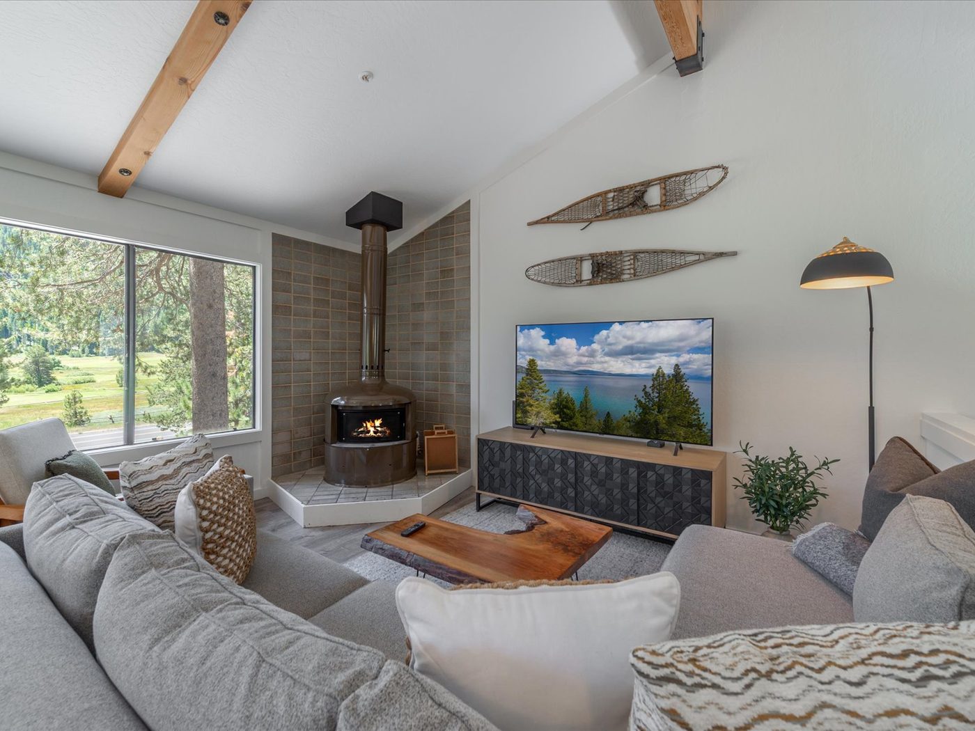 Open living room with vaulted ceilings and oversized windows